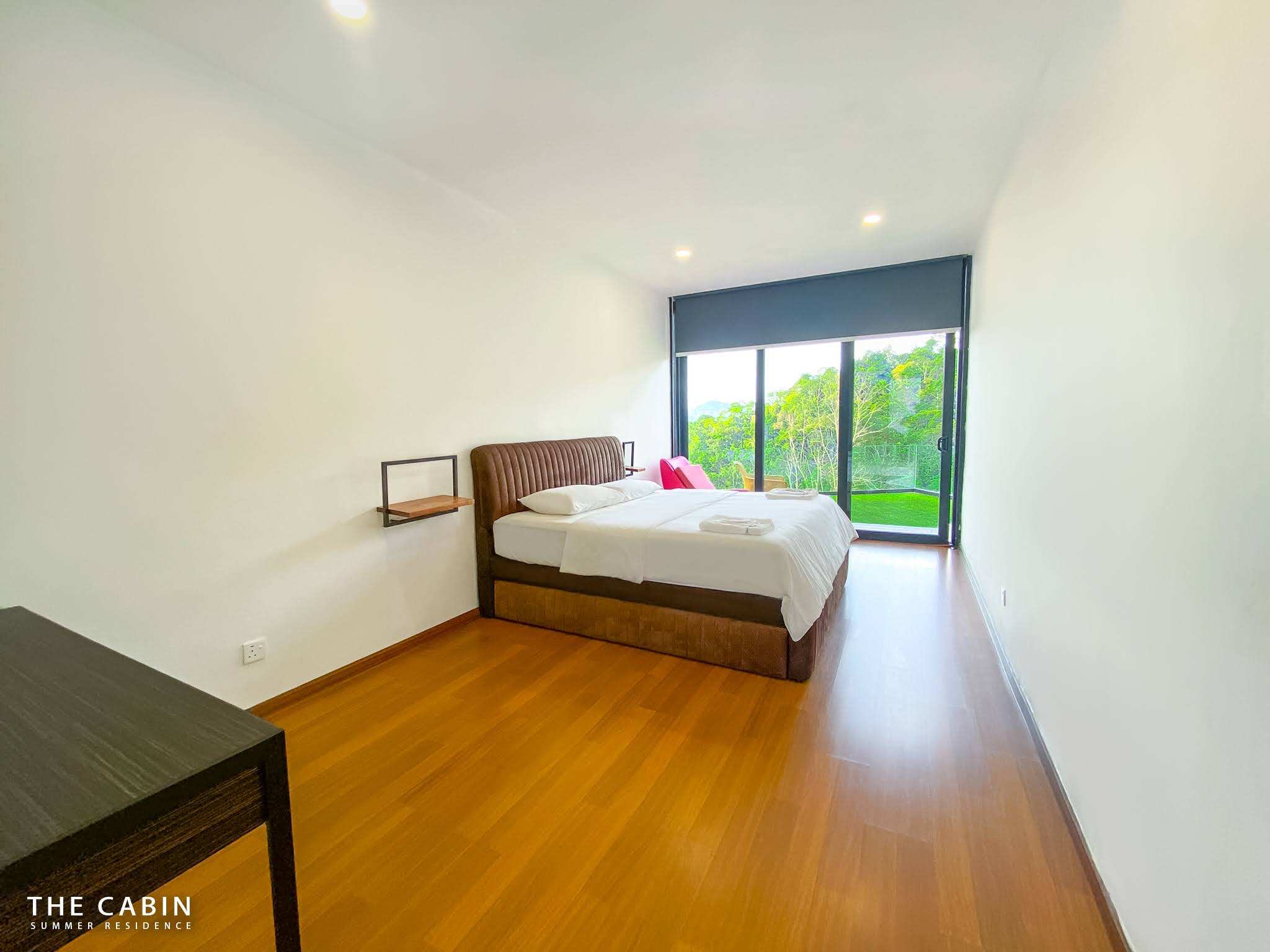 Room 3 from the doorway: bed, wall shelf, desk and sliding doors to the mountain view.