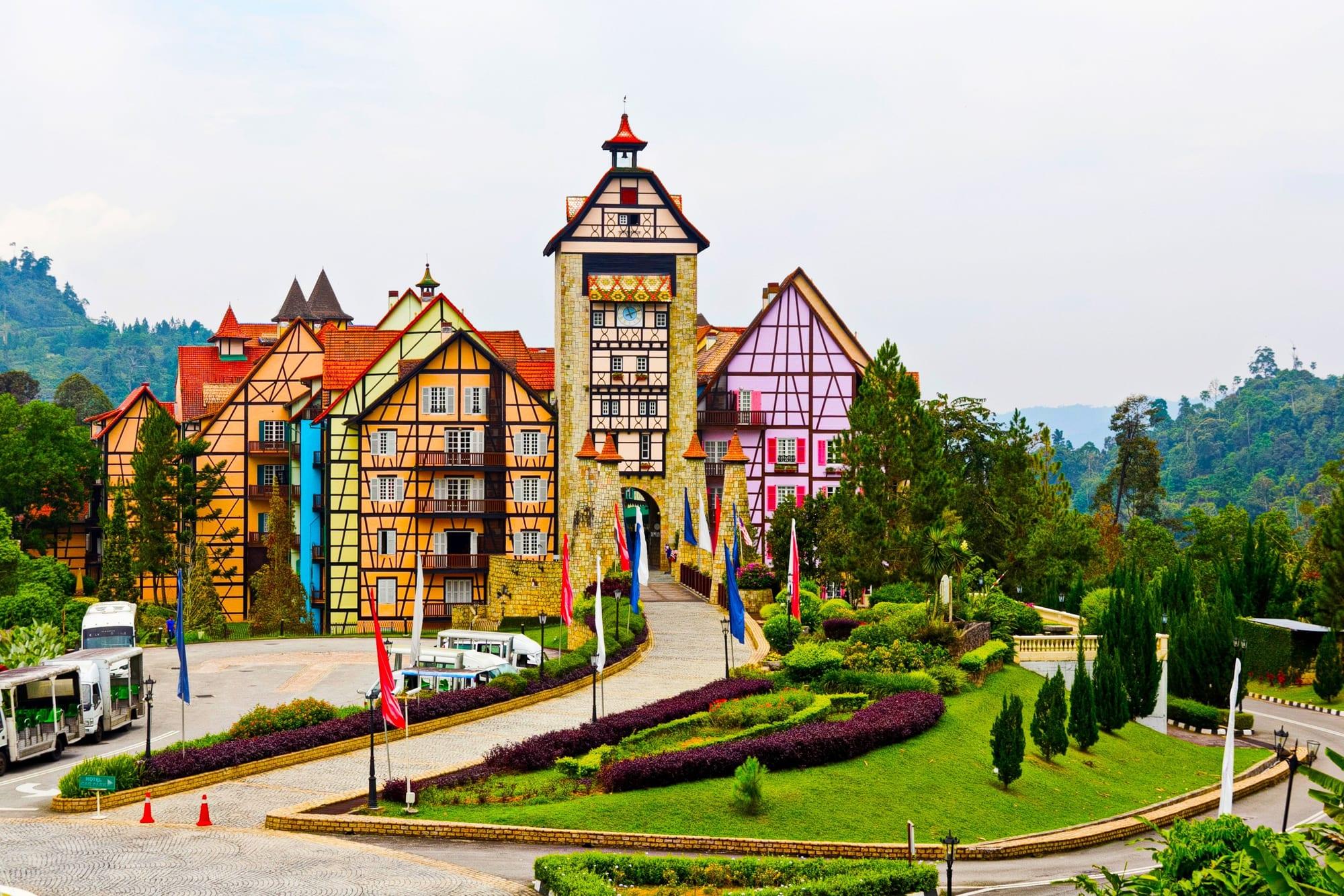 The half-timbered clock tower and painted facades of Colmar Tropicale on the Bukit Tinggi ridge