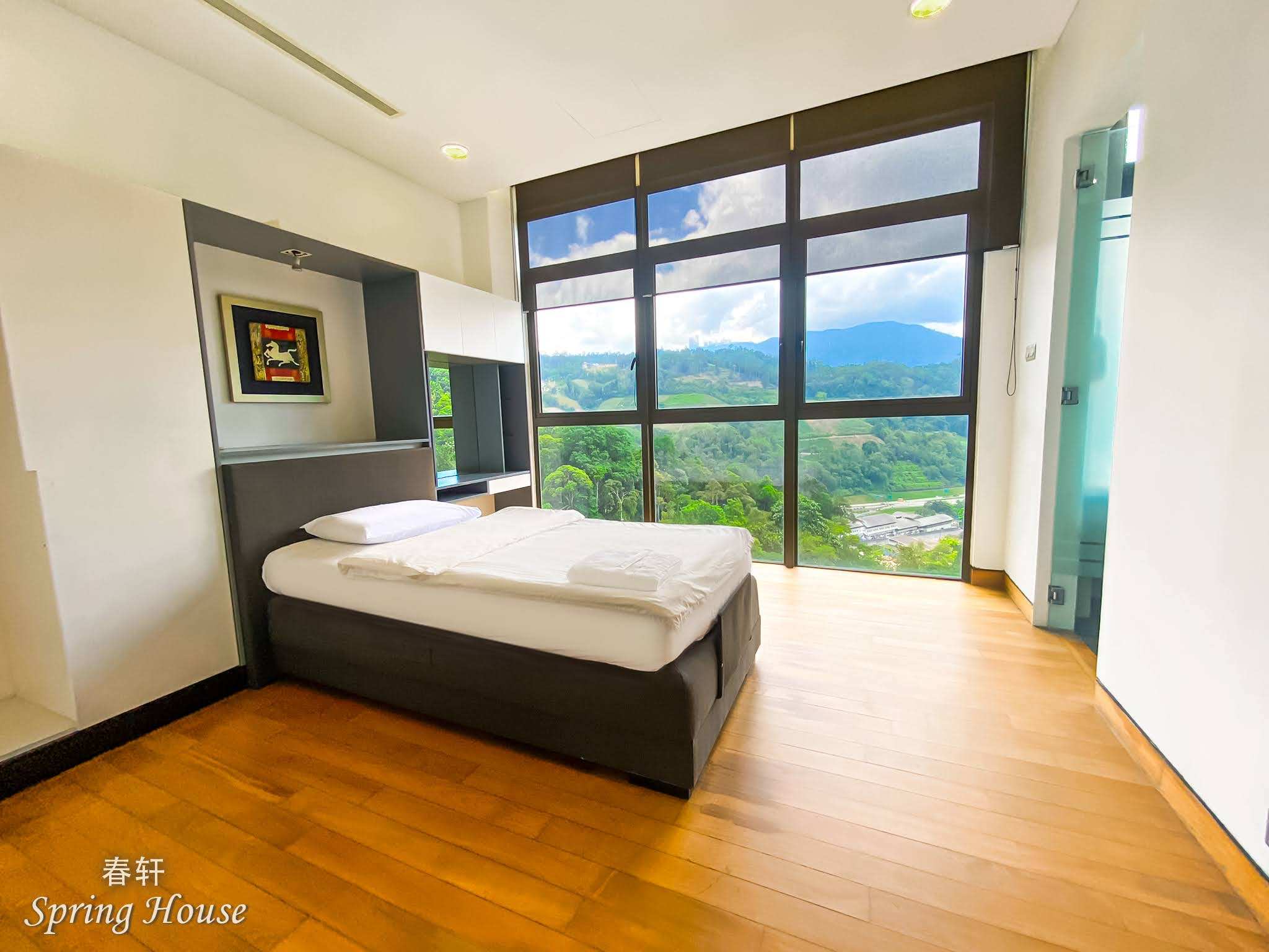 Open-air ensuite: artificial turf floor, frosted-glass toilet cubicles and an open sink counter behind bifold glass doors.
