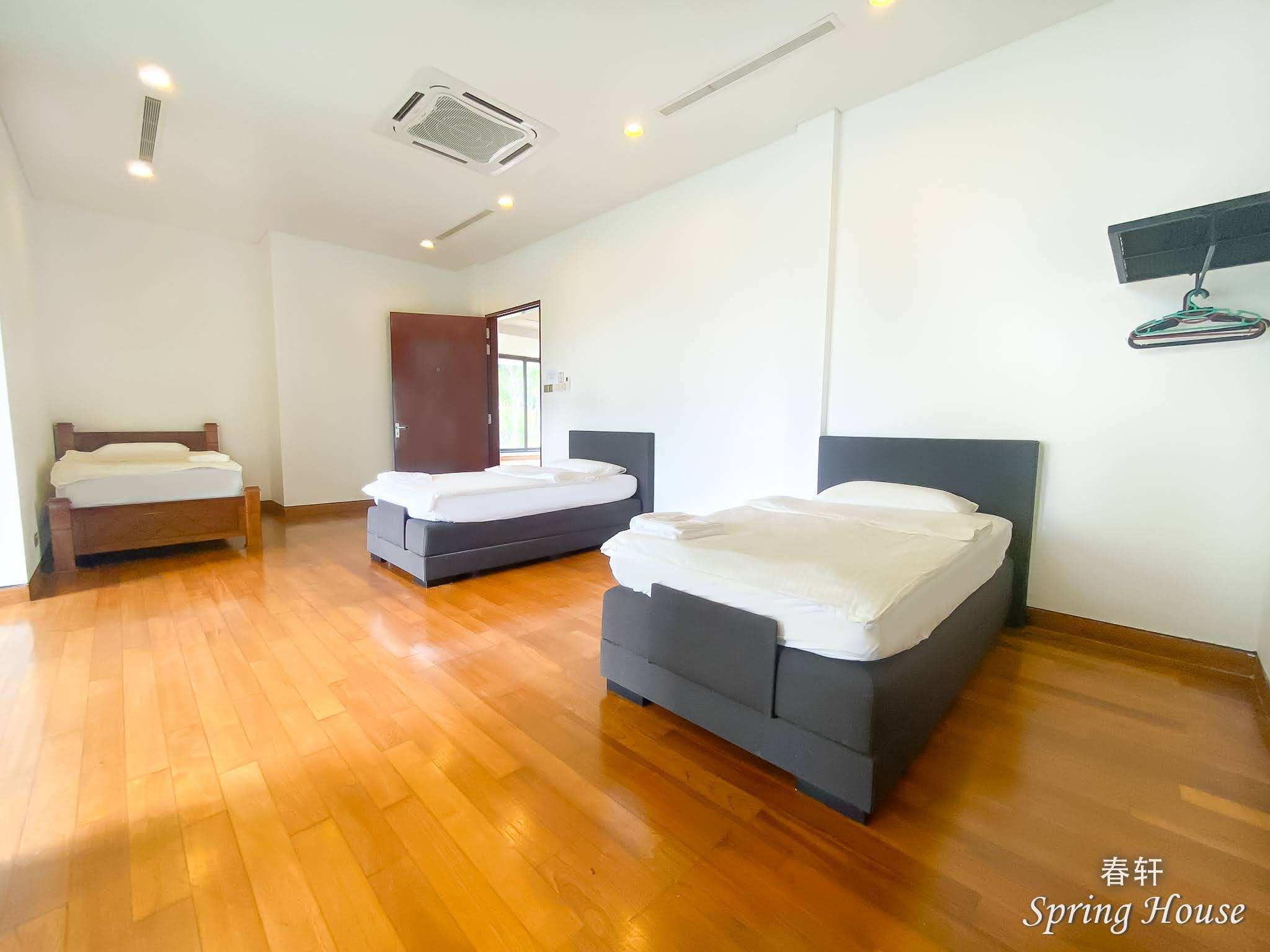 Bedroom with a dark upholstered king bed and floor-to-ceiling windows over the mountain valley.