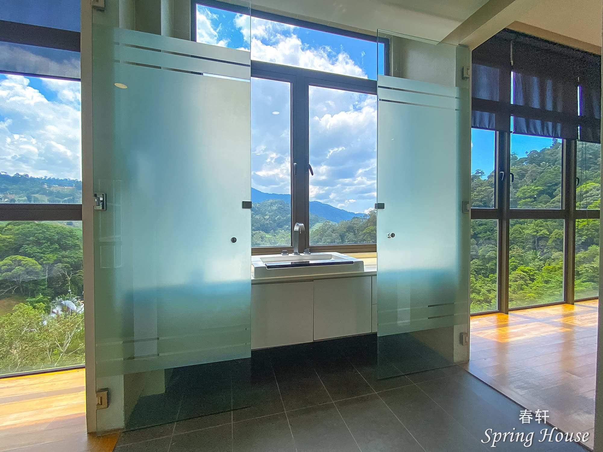 Ensuite with sliding frosted-glass doors and a sink and mirror set between the panels.